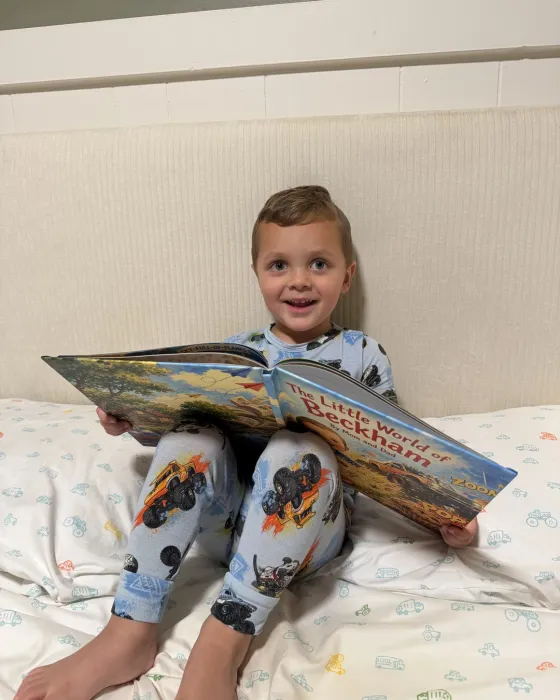A child reading an open personalized Sundayfawn storybook
