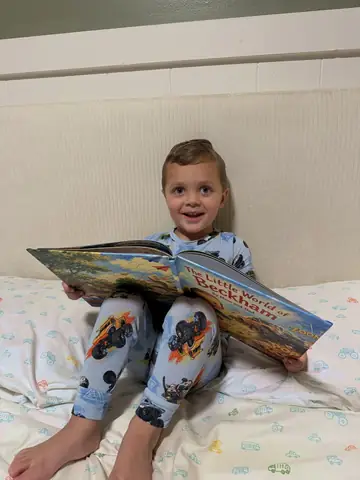 A child holding his personalized Sundayfawn storybook