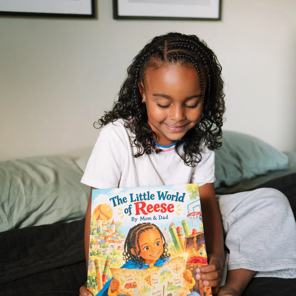 Reese holding The Little World of Reese with her name and illustrated character visible on the printed cover